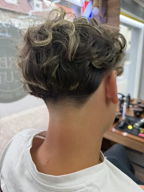 Lockige Haare mit Taper im Nacken